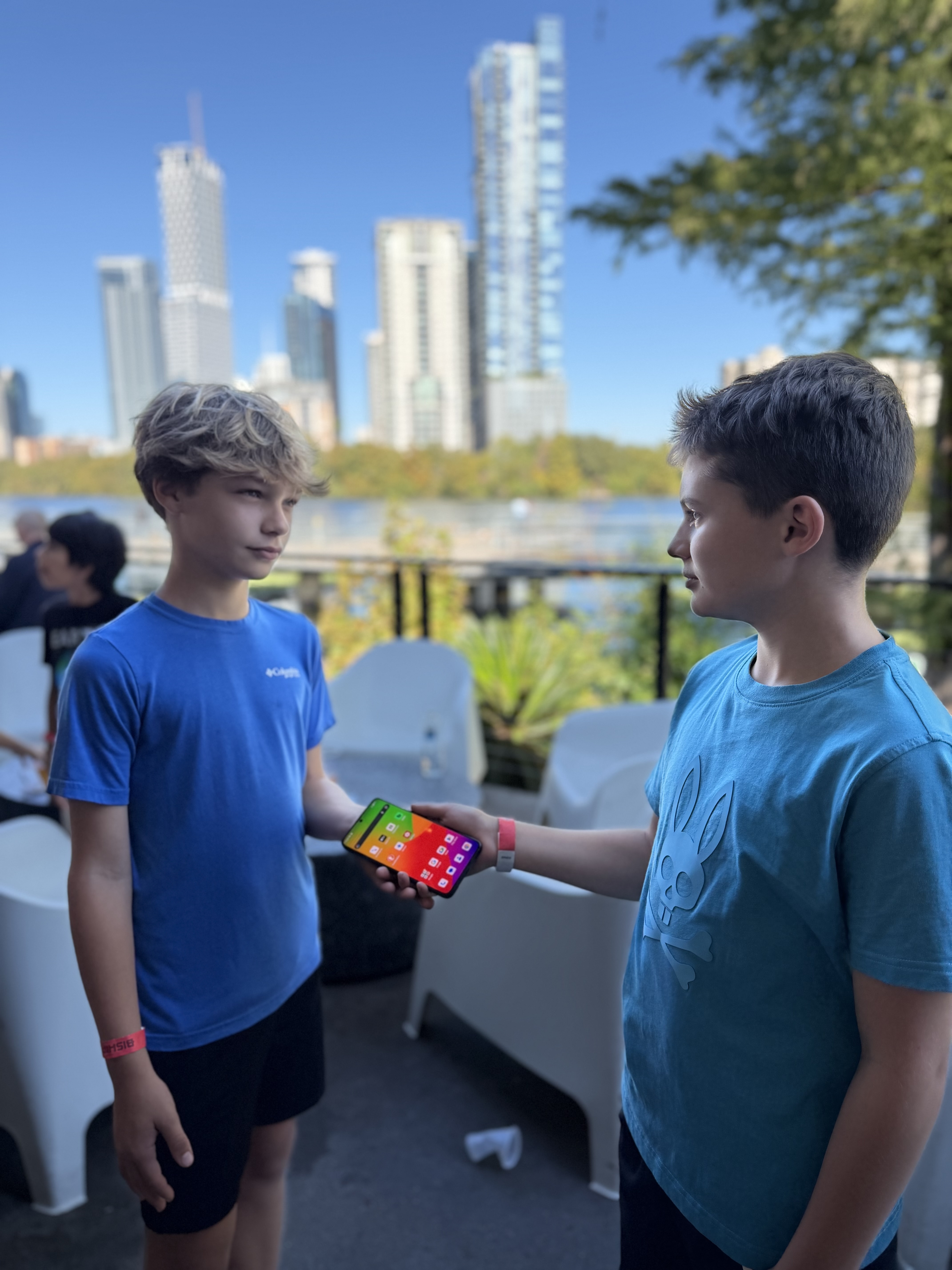Two young people sharing a look at the Hiroh Phone outdoors