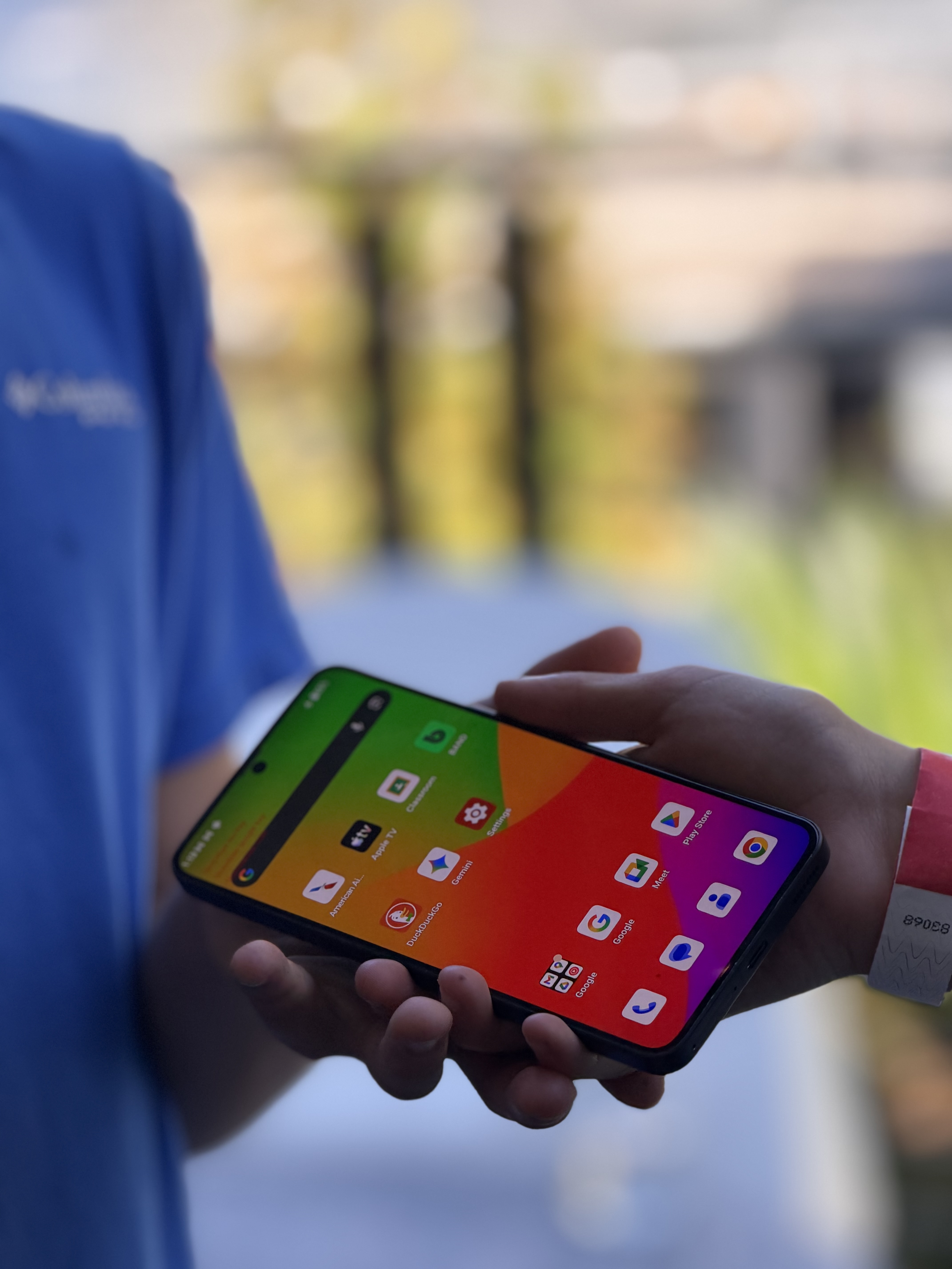 A close-up of the Hiroh Phone screen held in young hands