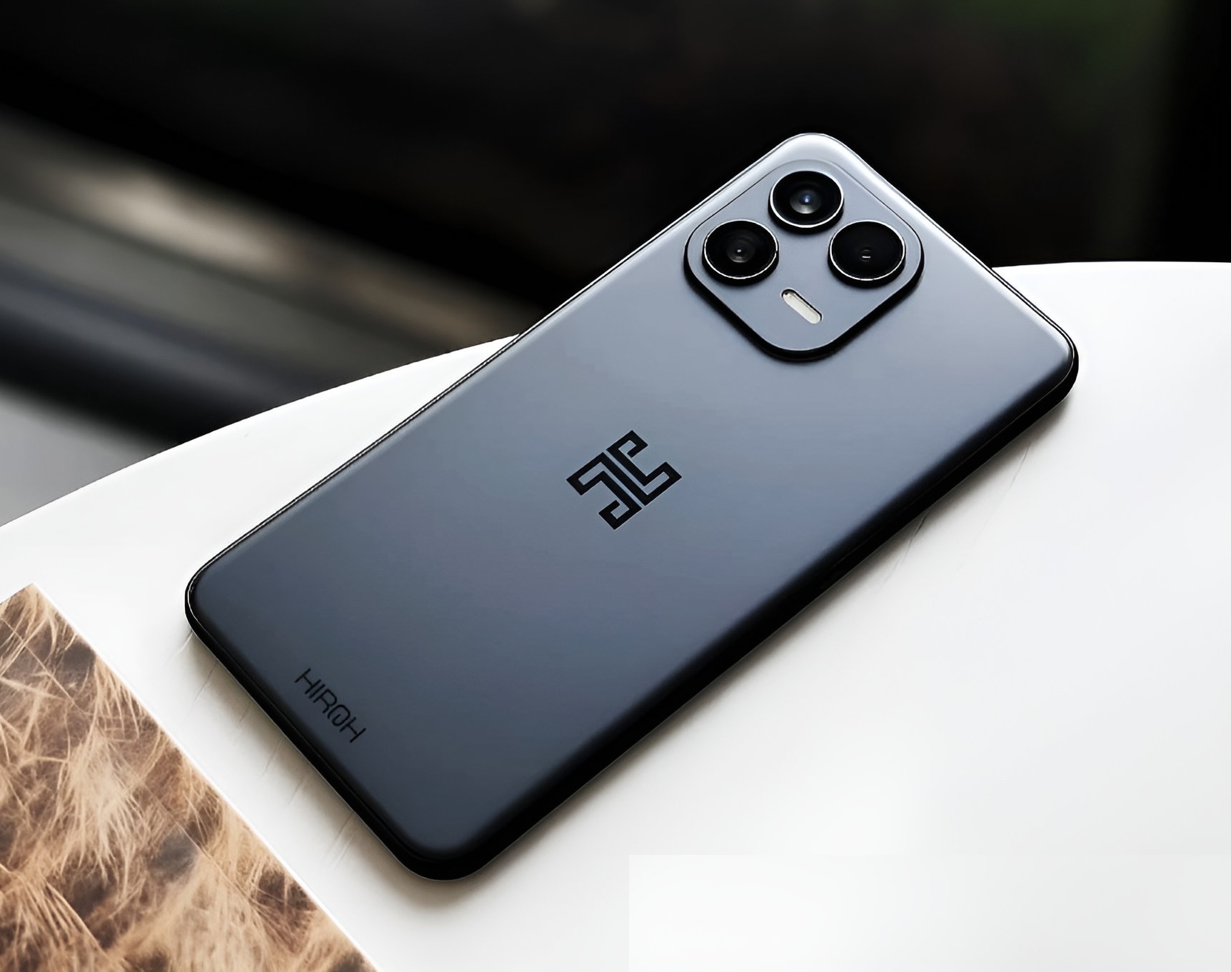 The Hiroh Phone in graphite, with its triple camera system and aluminum frame