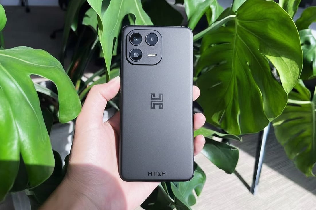 The back of the Hiroh Phone held against green foliage